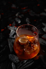  Whiskey with ice  on a background of burning charcoal.