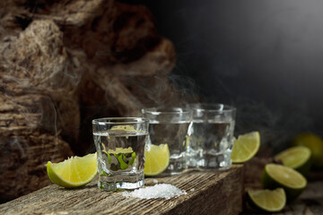 Tequila with salt and lime slices.