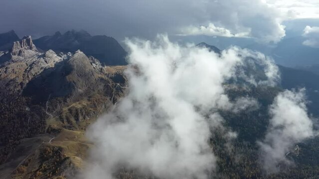 Tracking drone video showing low level clouds covering the Dolomites, Italy 