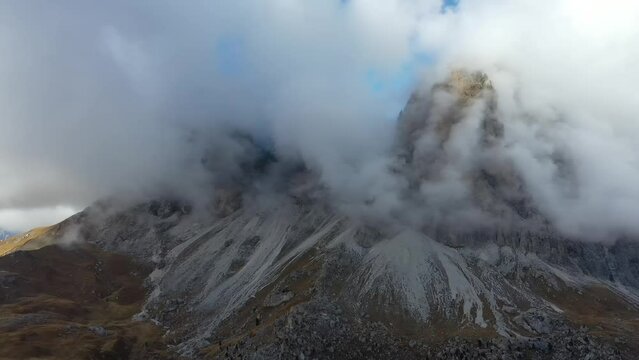 Tracking drone video showing low level clouds covering the Dolomites, Italy 