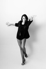 Passionate latina dancer in the studio is dancing in small black dress