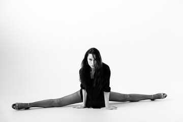 Passionate latina dancer in the studio is dancing in small black dress