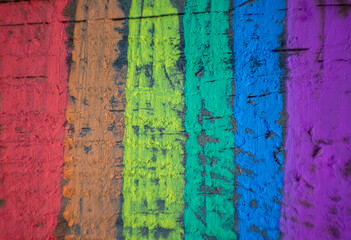 Wooden textured background with the rainbow flag, symbol of gay and freedom, painted with colored chalks
