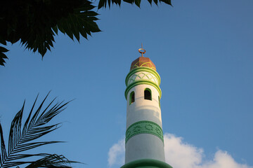 islamic mosque tower on blue sky