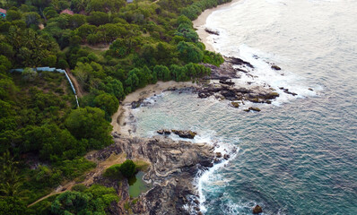 Obraz premium Aerial view of the tropical ocean landscape with a beach. Beautiful southern sea wallpaper for tourism and advertising. Asian landscape, drone photo