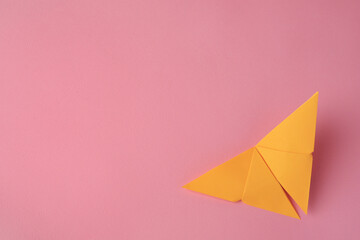 Origami art. Paper butterfly on pink background, top view. Space for text