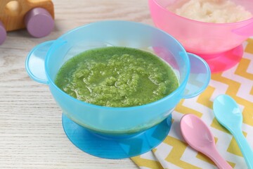 Healthy baby food. Different tasty puree in bowls on white wooden table