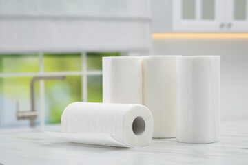 Many rolls of paper towels on white marble table in kitchen