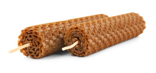 Stylish elegant beeswax candles isolated on white