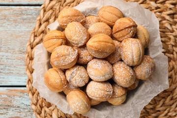 Bowl of delicious nut shaped cookies on grey wooden table, top view