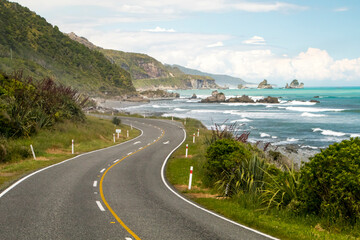 Winding and scenic road in New Zealand, along the ocean and hills