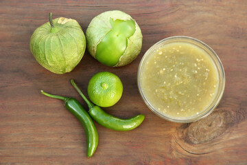 Tasty salsa sauce and ingredients on wooden table, flat lay