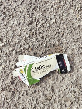 broken box of cialis abandoned on the street