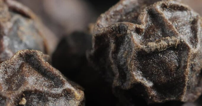 Peppercorns or black pepper spice. Super Macro Close Up.