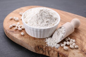 Fototapeta na wymiar Bean flour and seeds on grey table