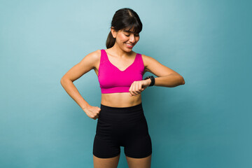 Fototapeta na wymiar Smiling woman using a smartwatch during exercise