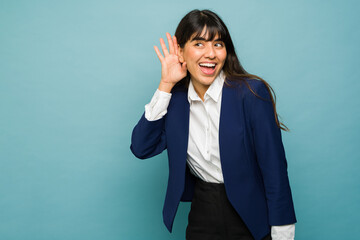 Cheerful businesswoman spying listening a secret