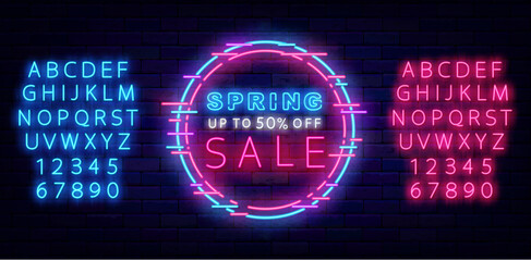 Spring sale neon sign on brick wall. Season special offer. Laser turquoise and pink alphabet. Vector illustration