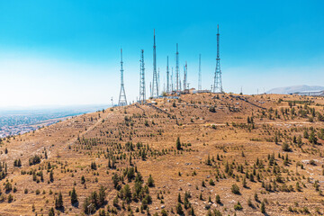 Communication cell and radio and TV broadcasting connection towers on top of a hill