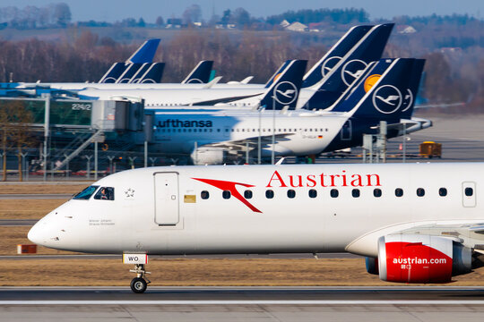 Austrian Airlines Embraer 195 at Munich Airport with Lufthansa Aircraft in Background, 16 Feb 2023