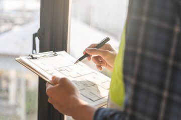 Building inspection, asian contractor young man, male inspecting home, reconstructed construction,...