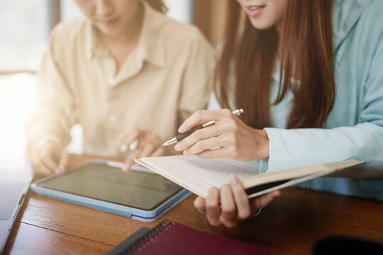 Asian Student girl High School Tutor Individual Tuition From Teacher In Library. University Student Tutor Books With Friends.