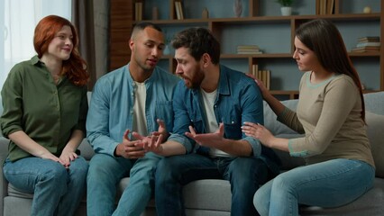 Stressed depressed sad man talking complaints discuss life problems grief in group therapy session at home diverse multiracial men and women calm friend give psychological help trust support empathy