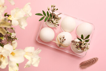 Festive composition with eggs and floral decor on pink background, flat lay. Happy Easter
