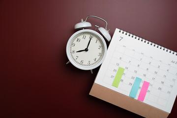 close up of calendar and alarm clock on the table background, planning for business meeting or travel planning concept