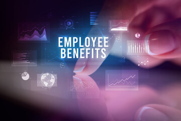 Finger touching tablet with business graphs and icons concept