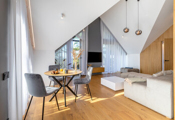 The Stylish Spacious Luxury Interior Design of Living Room with Design Gray Sofa, Coffee Table, Decoration, Pillows in Modern Home Decor. Modern Living Room