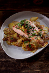 Roasted fish with herbs and potato slices