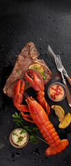 Delicious roasted meat and lobster served with sauces