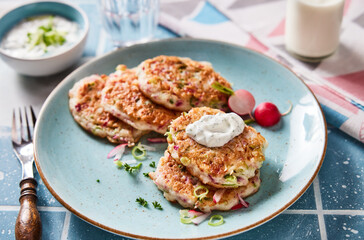 Tasty fritters with onion on plate