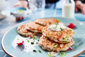Delicious fritters with onion and sour cream