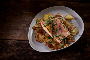 Appetizing fried potatoes with salmon