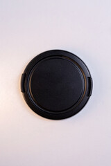 black protective cover for the camera lens, isolated on a white background