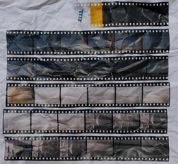 set of retro long 35mm positive strips printed on white crumpled paper, contact sheet with empty...