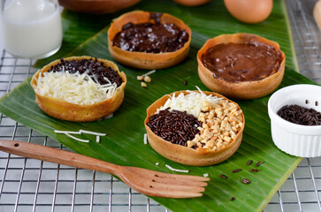 Martabak Terang Bulan mini, martabak manis mini or mini sweet martabak (mattabak), is Indonesian popular street food, made from flour, egg, yeast, topped with peanuts with chocolate
