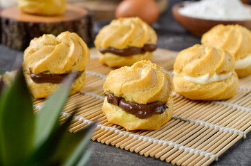 Homemade eclairs with chocolate or vanilla filling
