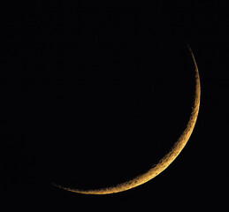 crescent moon rising in the evening, new orange moon
