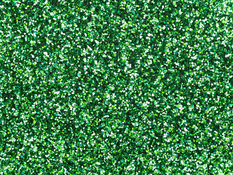Dark green glitter. Perfect holographic background or pattern of sparkling shiny glitter for decoration and design of Christmas, New Year, Patrick Day, xmas gift card, 3d or other holiday pictures.