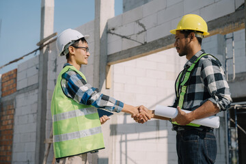 construction worker and contractor. Client shaking hands with team builder in renovation site.