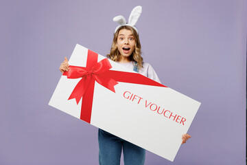 Young woman wear casual clothes bunny rabbit ears hold store big gift certificate coupon voucher...