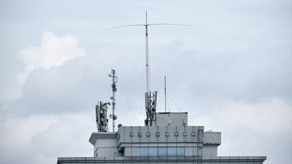 Top of Building with Signal Transmitters and Messy Cables