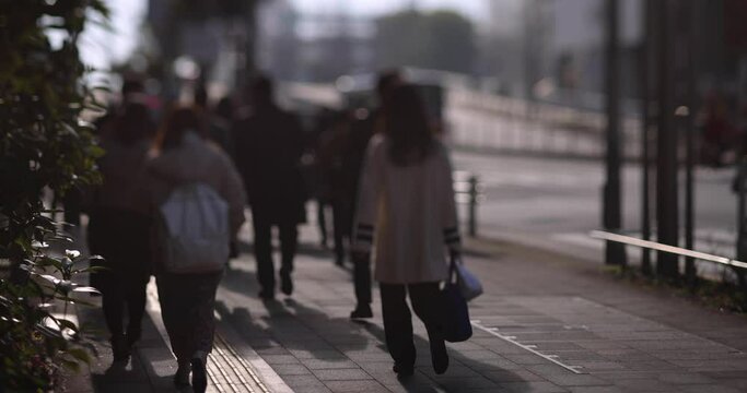 A slow motion of walking people on the city street defocused
