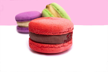 Sweet colorful macarons isolated on white background. Tasty red, green, brown, violet macaroons.