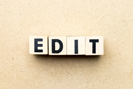 Alphabet letter block in word edit on wood background