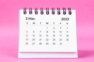 Obraz na płótnie Canvas The beautiful March 2023 desk calendar on pink color background.