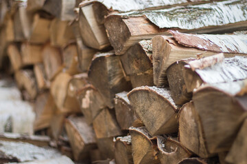 Pile of firewood. Birch bark and wood logs. Stack of birch logs. Chopped tree trunk. Hardwood close up. Ecology energy. Natural fuel. Countryside lifestyle.